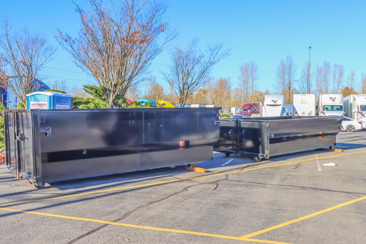 Professional dumpster rental service with roll-off container on residential driveway in Little Chute